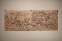two pieces of paper hanging on a wall