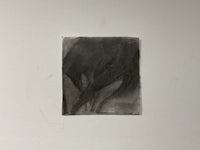 a black and white drawing hanging on a wall